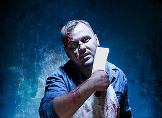 Image showing Bloody Halloween theme: crazy killer as butcher with a knife