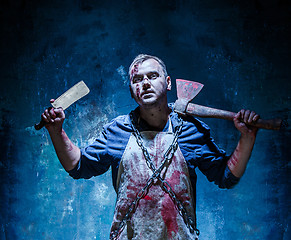 Image showing Bloody Halloween theme: crazy killer as butcher with an ax