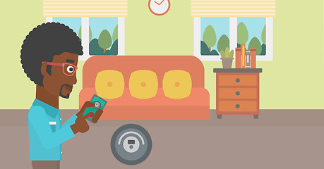 Image showing Man controlling vacuum cleaner with smartphone.