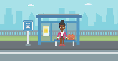 Image showing Woman waiting for bus at the bus stop.