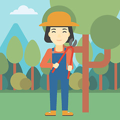 Image showing Female farmer using pruner vector illustration.