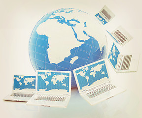 Image showing Laptops around the planet earth . 3D illustration. Vintage style