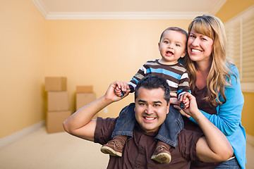 Image showing Young Mixed Race Family In Room With Moving Boxes