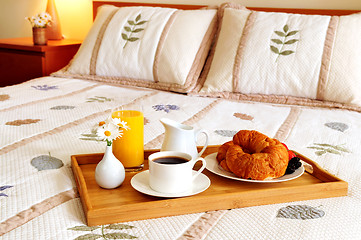 Image showing Breakfast on a bed in a hotel room