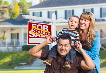 Image showing Young Family in Front of Sold Real Estate Sign and House
