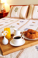 Image showing Breakfast on a bed in a hotel room