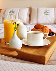 Image showing Breakfast on a bed in a hotel room