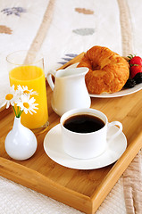 Image showing Breakfast on a bed in a hotel room