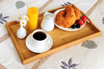 Image showing Breakfast on a bed in a hotel room