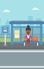 Image showing Woman waiting for bus at the bus stop.