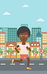 Image showing Woman running with earphones and smartphone.