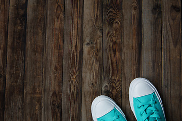 Image showing socks of sneakers on wooden floor