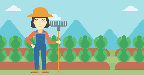 Image showing Female farmer with rake vector illustration.