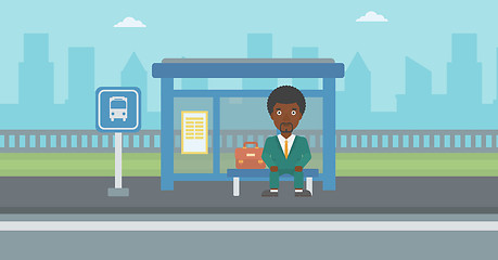 Image showing Man waiting for bus at the bus stop.