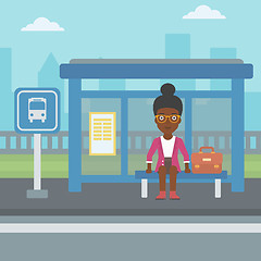 Image showing Woman waiting for bus at the bus stop.