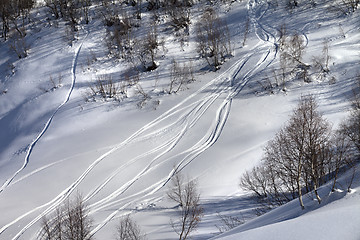 Image showing Off-piste slope with track from ski and snowboard in sunny day