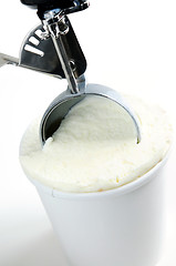 Image showing Tub of vanilla ice cream with a scoop