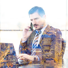 Image showing Businessman in office working on laptop computer.