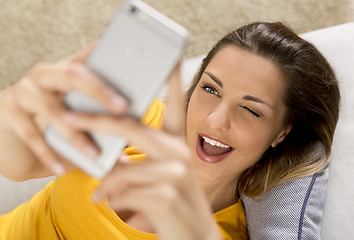 Image showing Happy woman texting
