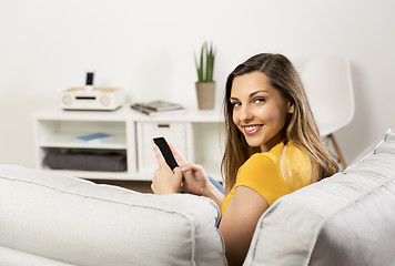 Image showing Happy woman texting