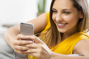 Image showing Happy woman texting