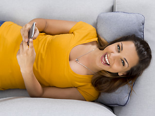 Image showing Happy woman texting