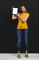 Image showing Woman holding and showing a tablet