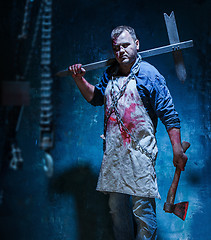 Image showing Bloody Halloween theme: crazy killer as butcher with an ax