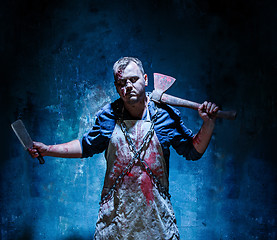 Image showing Bloody Halloween theme: crazy killer as butcher with an ax