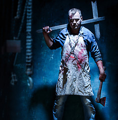 Image showing Bloody Halloween theme: crazy killer as butcher with an ax