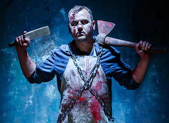 Image showing Bloody Halloween theme: crazy killer as butcher with an ax