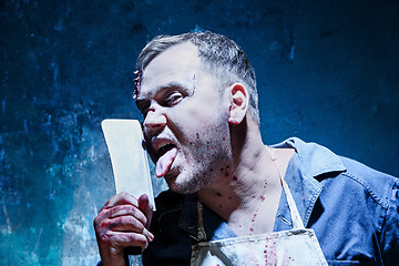 Image showing Bloody Halloween theme: crazy killer as butcher with a knife