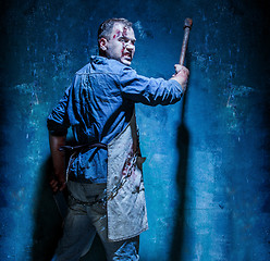 Image showing Bloody Halloween theme: crazy killer as butcher with an ax