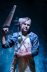 Image showing Bloody Halloween theme: crazy killer as butcher with saw