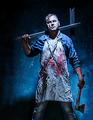 Image showing Bloody Halloween theme: crazy killer as butcher with an ax