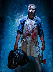 Image showing Bloody Halloween theme: crazy killer as butcher with an ax