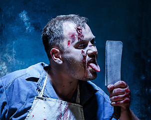 Image showing Bloody Halloween theme: crazy killer as butcher with a knife