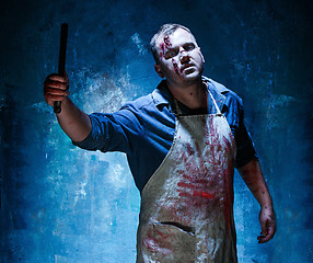 Image showing Bloody Halloween theme: crazy killer as butcher with a knife