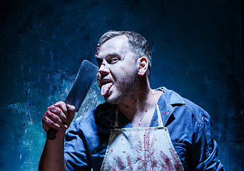 Image showing Bloody Halloween theme: crazy killer as butcher with a knife