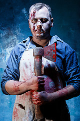 Image showing Bloody Halloween theme: crazy killer as butcher with an ax