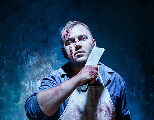 Image showing Bloody Halloween theme: crazy killer as butcher with a knife