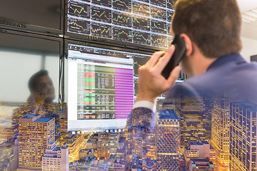 Image showing Stock trader looking at computer screens.