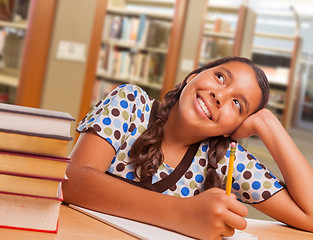 Image showing Hispanic Girl Student Daydreaming While Studying in Library