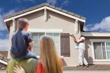 Image showing Young Family Watching House Get Painted by Painter