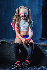 Image showing The funny crasy girl with candy on dark background