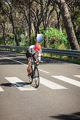 Image showing Grosseto, Italy - May 09, 2014: The cyclist without an arm and feet with the bike during the sporting event