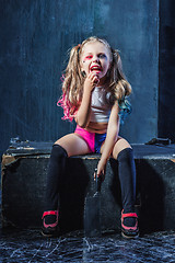 Image showing Horror shot: a scary evil girl with bloody knife