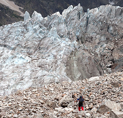 Image showing Hiker on glacier moraine