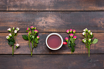 Image showing Cup of coffee with roses, top view