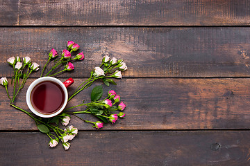 Image showing Cup of coffee with roses, top view